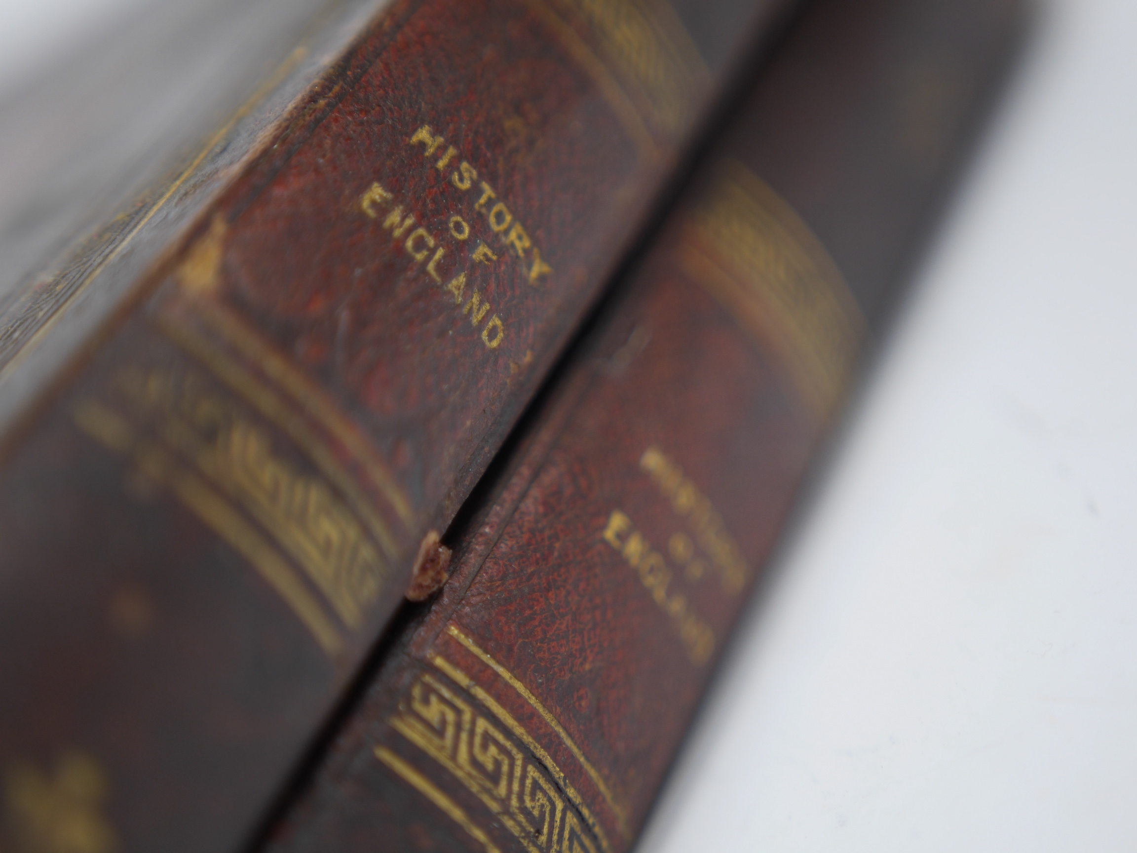 Two Victorian leather bound folding games compendium boards, both as mock bindings; English Games & History of England, with a set of bone draughtsmen. Condition - fair